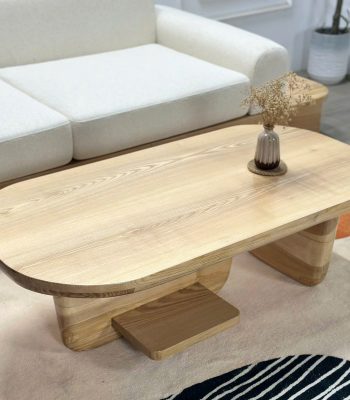 Hình ảnh cận cảnh mặt bàn arch bt0020 hình elip với những đường vân gỗ Tần bì uốn lượn tự nhiên. Góc chụp này tôn lên sự mịn màng của bề mặt gỗ và độ tinh tế trong việc xử lý các đường bo cong mềm mại